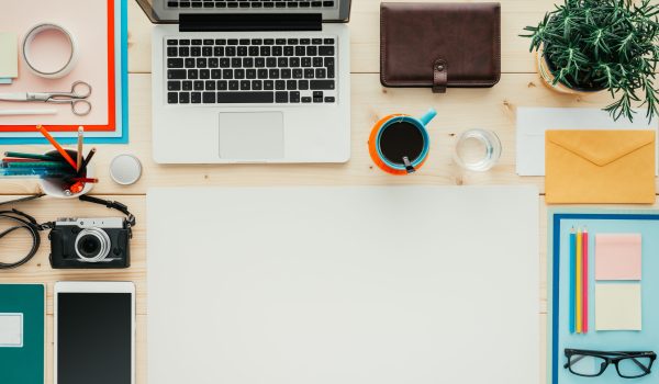 Creative contemporary desktop with laptop, digital tablet, camera and office supplies, flat lay banner with copy space